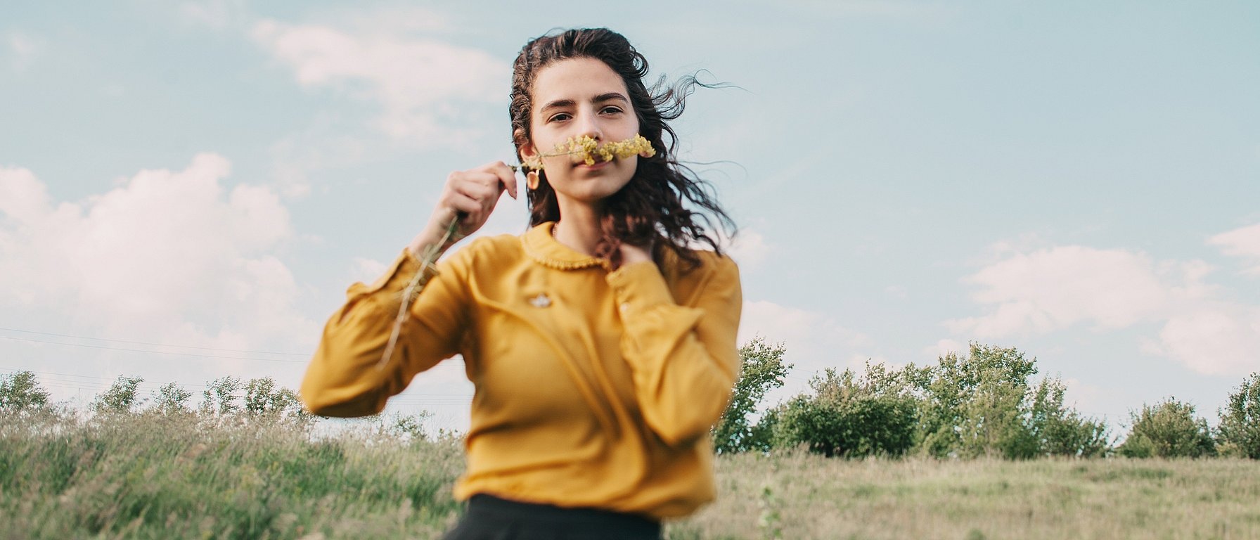 Young woman smelling flower